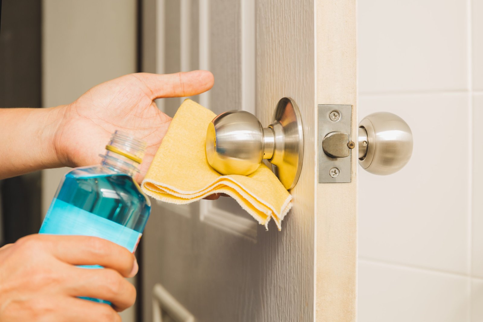 hand cleaning door knob with alcohol and yellow mi 2025 10 16 11 24 51 utc scaled